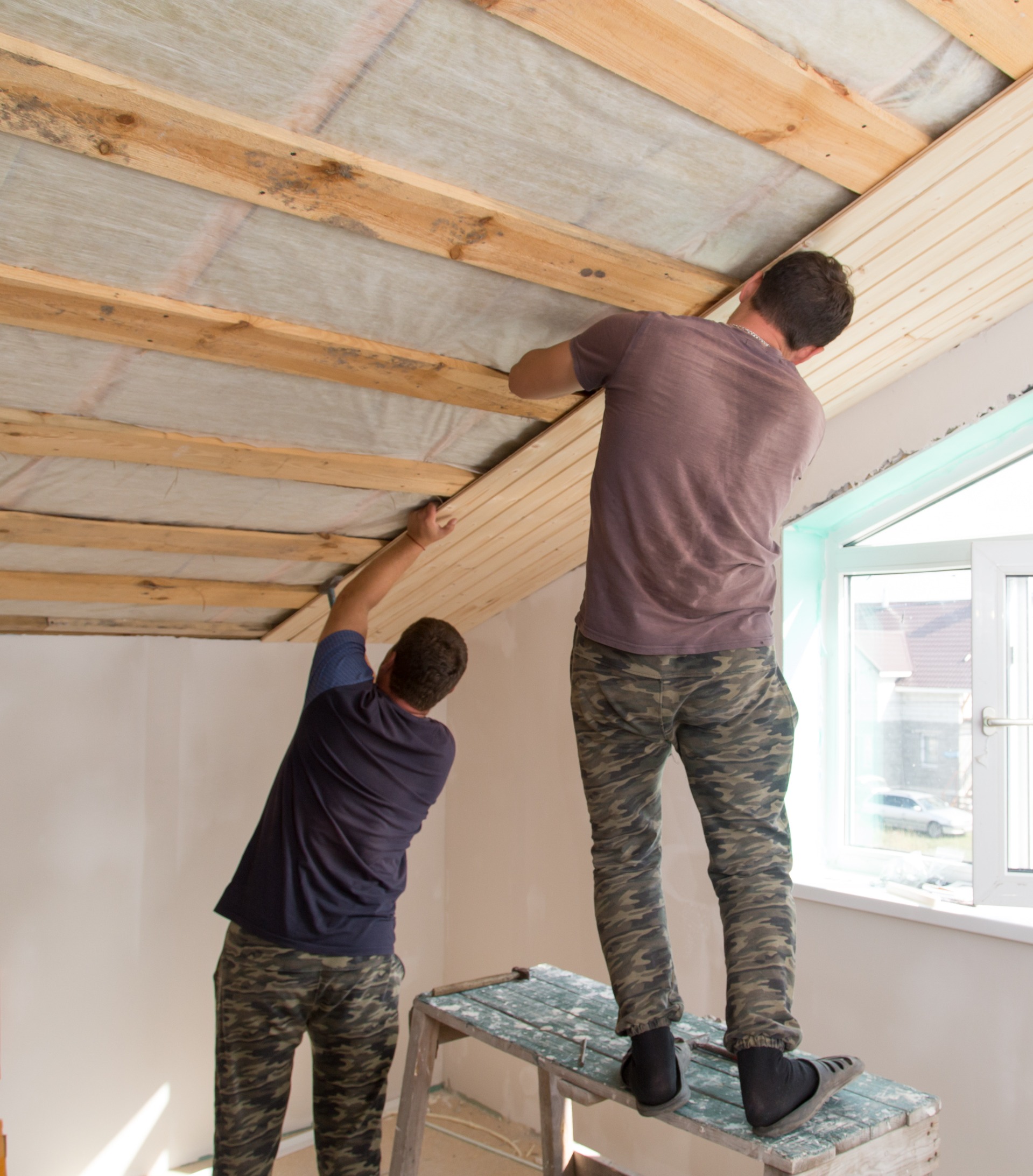 Workers installing attic insultion